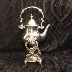 Tilting silver plated tea kettle with warmer.